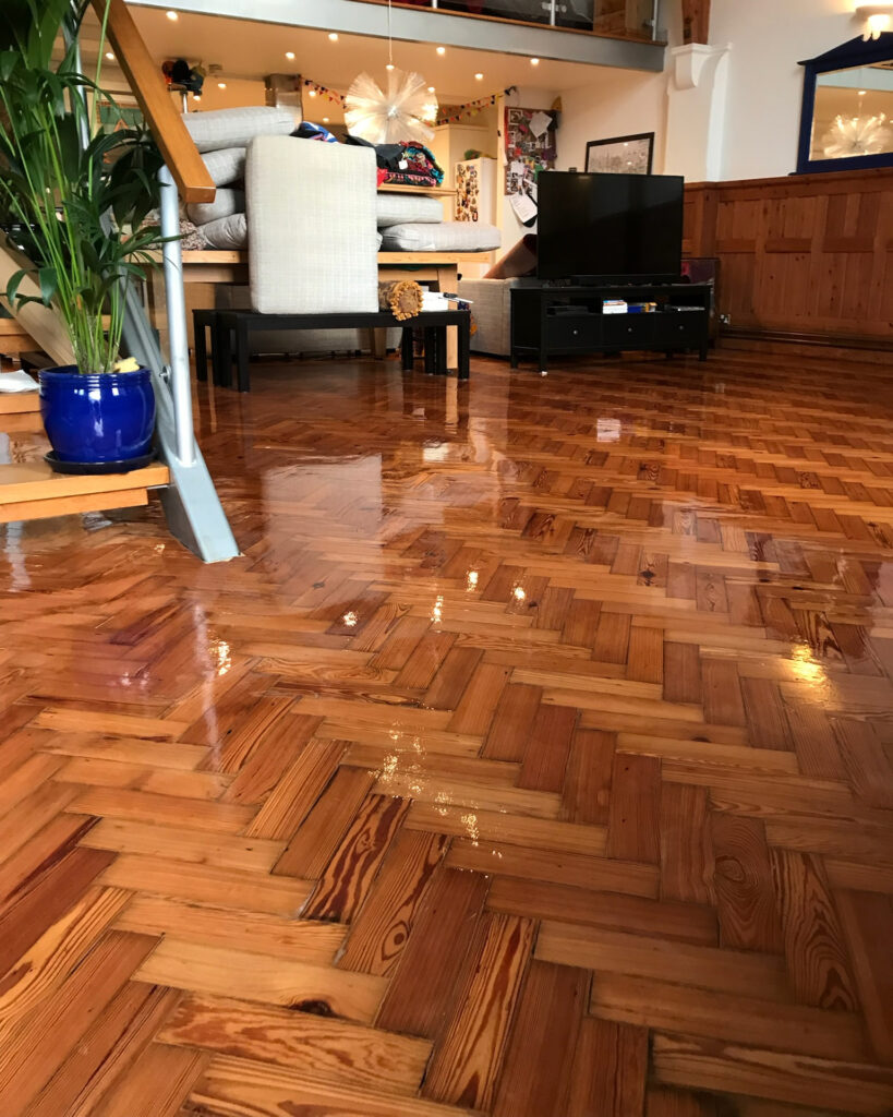 Image shows a living room in Kent with a parquet floor that has been sanded and refinished by Mark Antony & Sons
