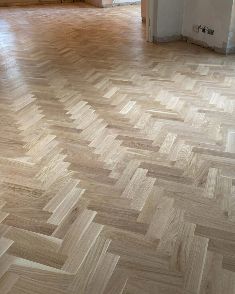 Image shows pale parquet flooring in a home in Kent. Freshly sanded parquet flooring by Mark Antony & Sons.
