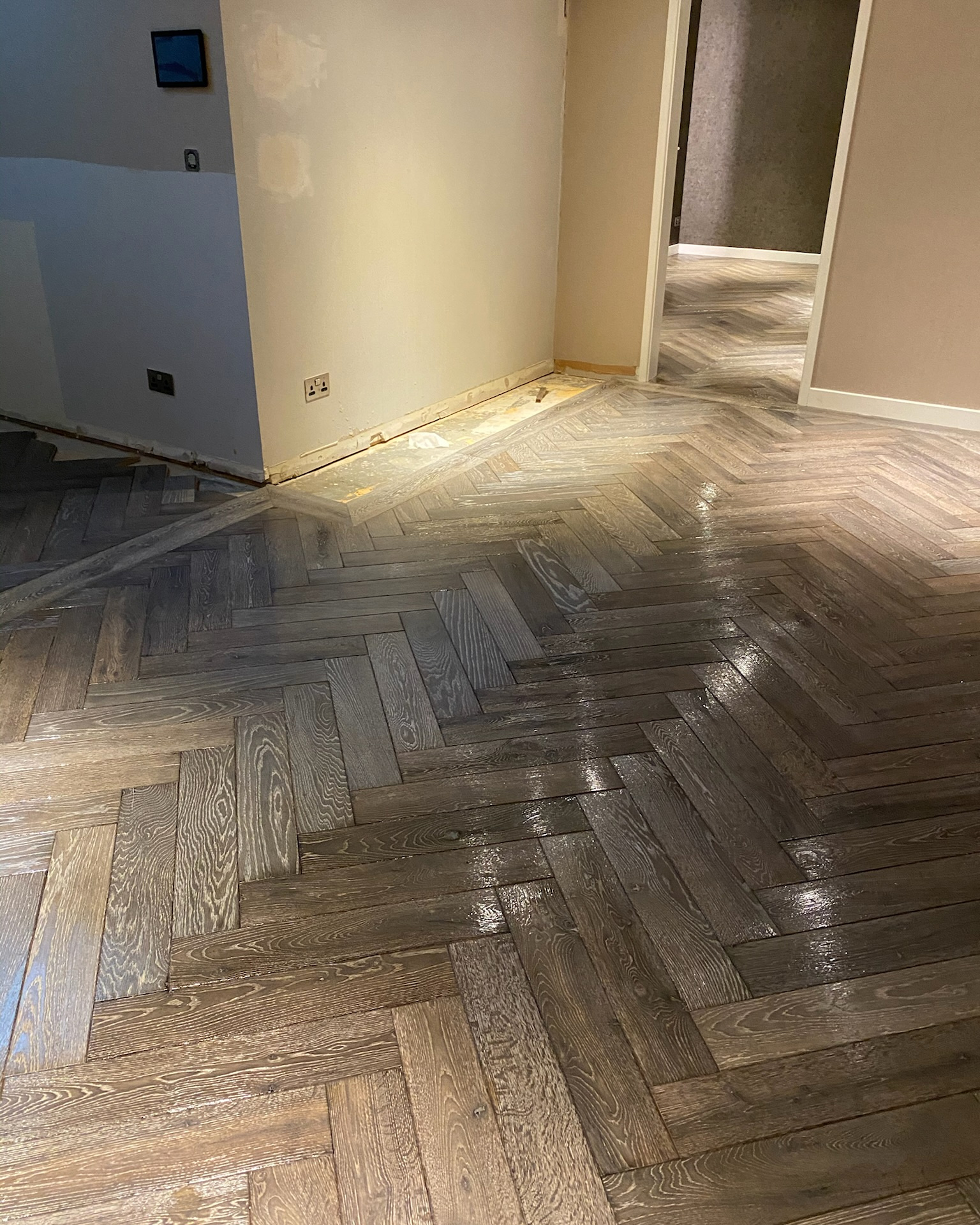 Image shows dark stained parquet flooring after being sanded and refinished by Mark Antony & Sons in Kent.